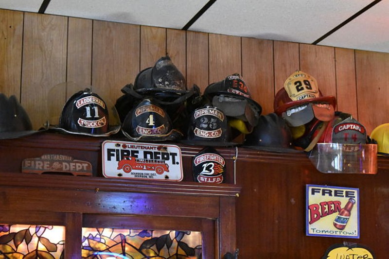 Just some of the firefighter paraphernalia lining the bar's walls. - PHOTO BY DANIEL HILL