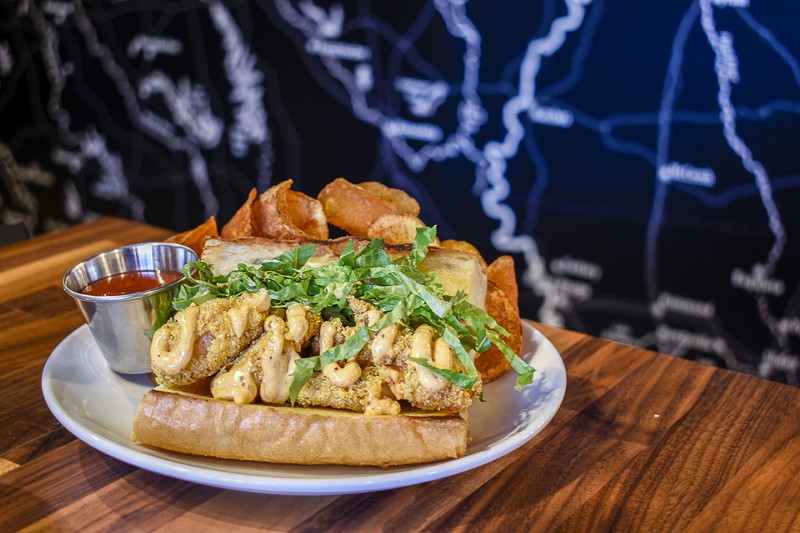 The shrimp po'boy is topped with remoulade and shredded romaine. - KELLY GLUECK