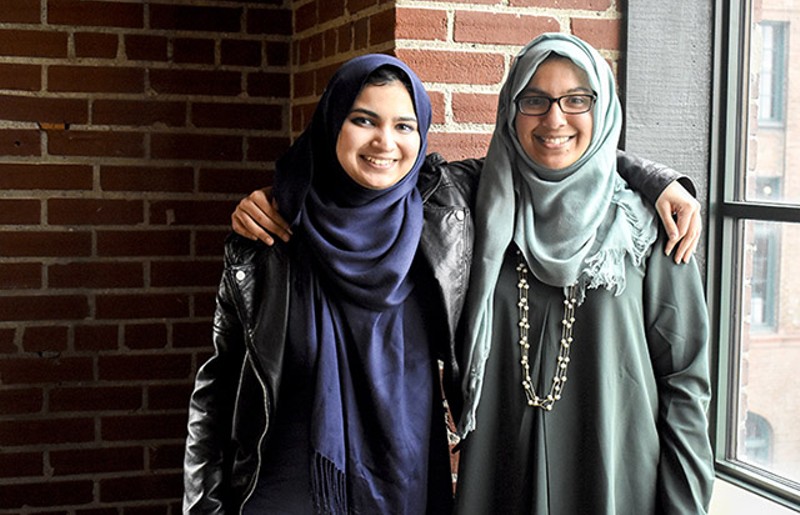 Yusra Ali (left) is the curator for the second annual Muslim Art Exhibit. Her younger sister Sadia (right) is helping her sister plan the event. - KELLY GLUECK