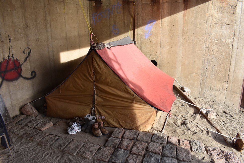 A small homeless camp has been erected in an alcove of the flood wall. - DOYLE MURPHY
