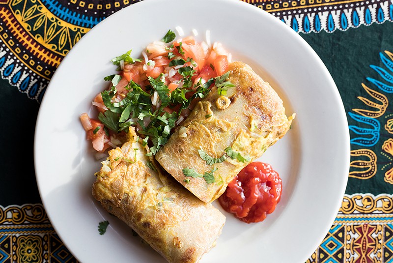 The "Rolex" is a flat bread filled with an omelet containing tomatoes, onions and green peppers. - MABEL SUEN