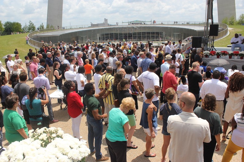 A large crowd gathered at the Arch's base. - ALISON GOLD