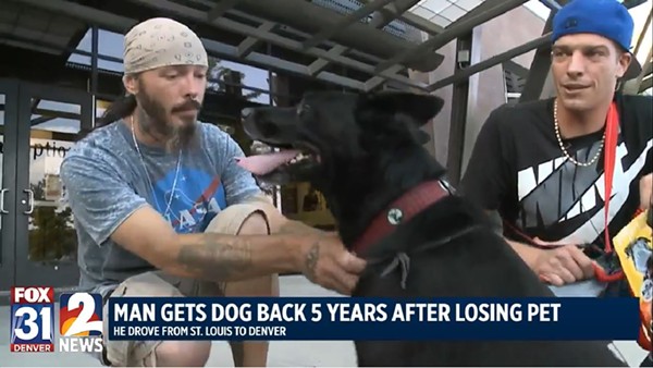 Molly the dog with her two owners. She's returning to St. Louis today with Jason Senseney, right. - Screenshot via Fox31