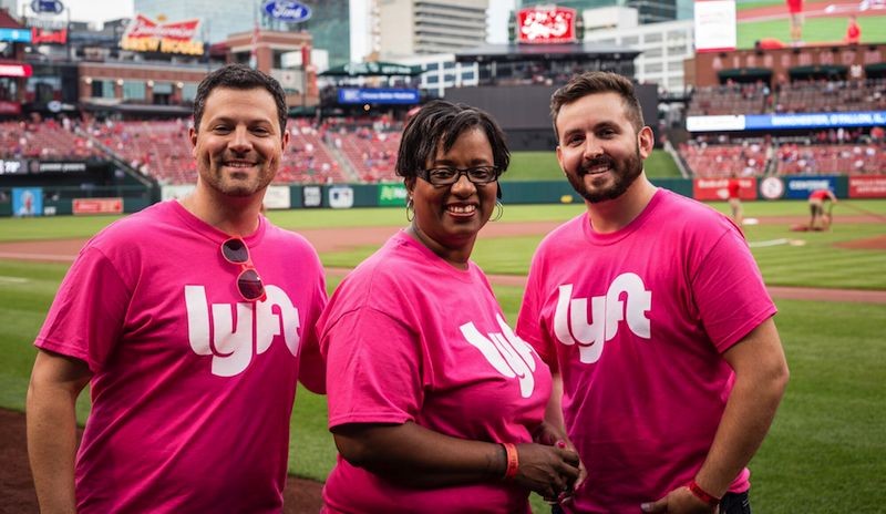 Lyft driver Michele Thompson, center, with Market Manager Joe Schlichter (left) and Marketing Associate Jeff Potzman. Thompson, a cancer survivor, threw out the first pitch at the Cardinals game on July 31. - COURTESY OF LYFT