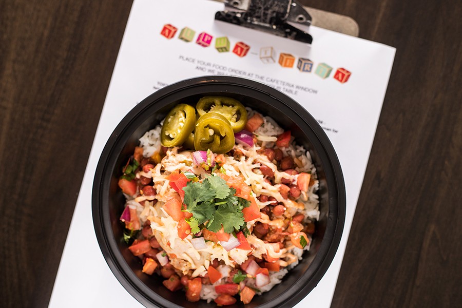The "Mojo Chicken Bowl" combines citrus-braised chicken, red beans, rice, chipotle cream, pico de gallo, Chihuahua cheese and pickled jalapenos. - MABEL SUEN