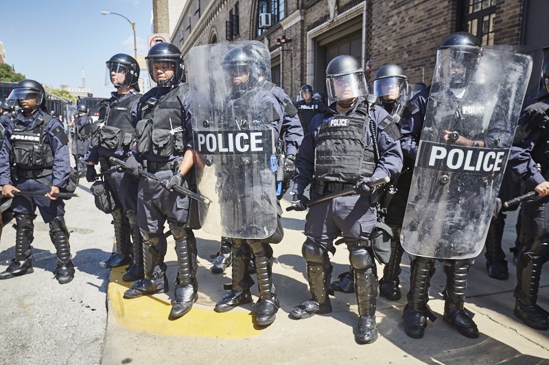 Expedia Touts the Real St. Louis Experience with Police Shields, Riot Gear