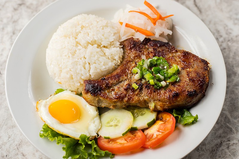 VP Square's char-grilled lemongrass pork chop is served with steamed rice and lime fish sauce. - MABEL SUEN
