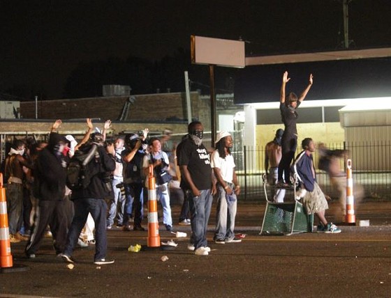 Protesters dragged traffic cones, bricks, shopping carts and other items to fashion a makeshift blockade on West Florissant Avenue. - DANNY WICENTOWSKI