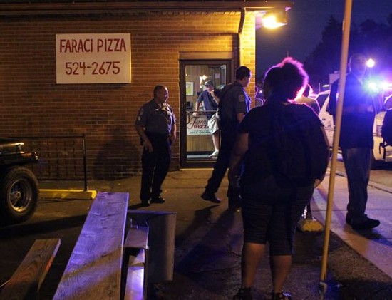 Protesters claim the owner of Faraci Pizza pointed a gun at them Thursday night, but the restaurant owner's wife says that's a lie. - Danny Wicentowski
