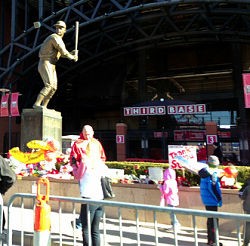 The Musial statue outside Busch Stadium has become a place of pilgrimage for the Cardinals faithful. - image via