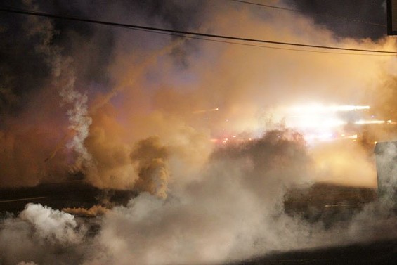 Tear gas wafts over West Florissant Avenue Sunday night - PHOTO BY DANNY WICENTOWSKI
