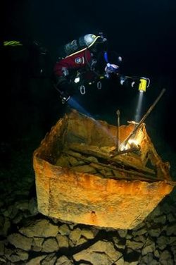 A diver examines an old iron ore cart abandoned in the Bonne Terre mines.