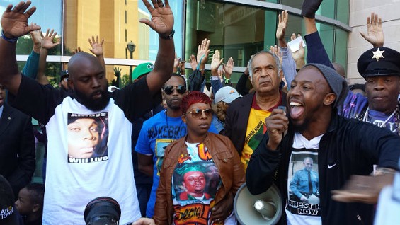 Michael Brown Sr., Lesley McSpadden and Pastor Carlton Lee in front of the Buzz Westfall Justice Center in Clayton Saturday. - Jessica Lussenhop