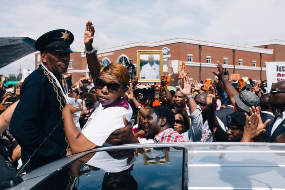 Lesley McSpadden, Michael Brown's mother, throws up the "Hands Up, Don't Shoot" sign at the Ferguson Police station. - All photos by Bryan Sutter