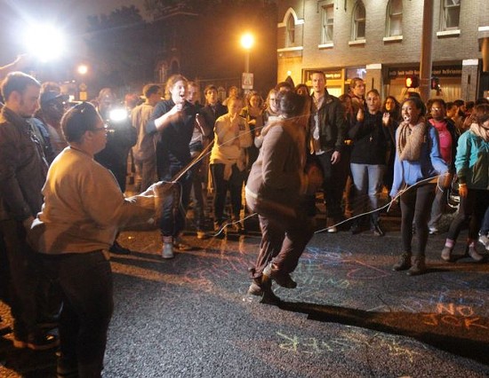 Protesters used hopscotch and other games while blocking an intersection in the Grove Sunday night.