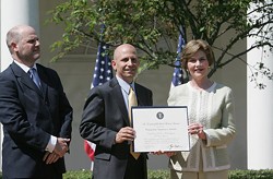 In 2007, John Steffen (far left) and another developer, Craig Heller, received recognition from First Lady Laura Bush.