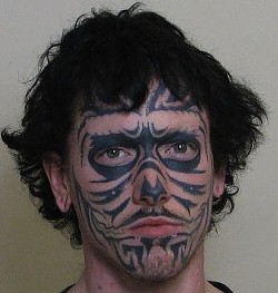 Adam Roberts and his real tattoo. - Madison County Sheriff's Office