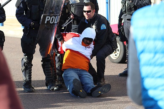 A protester gets arrested outside St. Louis Metropolitan Police headquarters on New Year's Eve morning. - Photos by Sadiyyah Rice