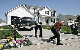 Investigators outside the Coleman home in May 2009.