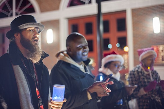 Jesse Kirk and Ray Carter sing in front of the Ferguson Fire Station on South Florissant Rd after handing out candy to local residents and fellow carolers.