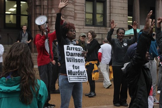 A protester outside St. Louis City Hall says she wants Darren Wilson indicted. But where is he? - Danny Wicentowski