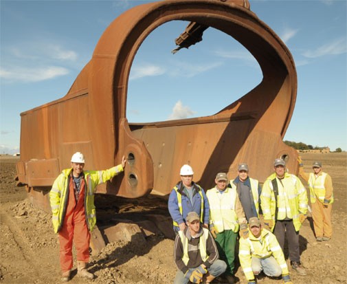 Workers pose before a dragline bucket in the United Kingdom. - widdrington.journallive.co.uk