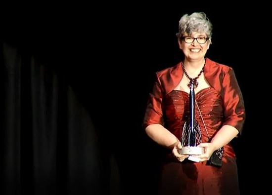 Shrewsbury resident Ann Leckie holds up her Hugo Award for Best Novel at the World Science Fiction Convention in London on August 17. - via