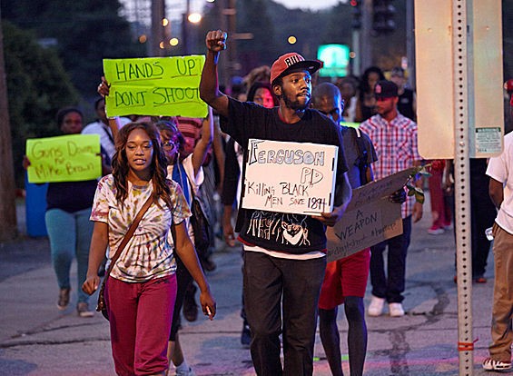 Protesters march in Ferguson on August 18. - Steve Truesdell