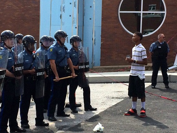 Davion Lorich asks police officers in Ferguson if they feel bad about what happened to Michael Brown. - Mitch Ryals