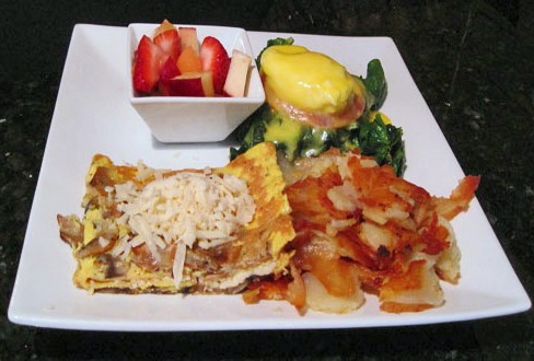 Eggs florentine and ka&#x15F;ar cheese omelet, portions thoughtfully split between two plates. - Kristie McClanahan