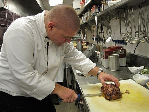 Hanley slices the finished meatloaf, which is filled with goat cheese and tapenade - Robin Wheeler