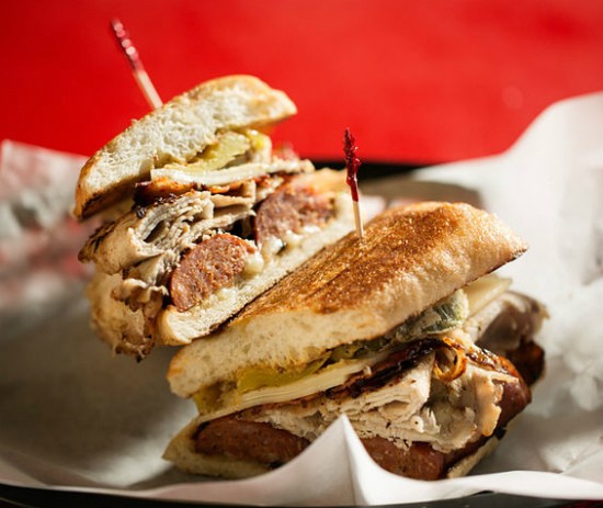 The "Pat Say Jack" sandwich at the Kitchen Sink features grilled andouille, roasted pork loin, jalape&ntilde;o bacon, Swiss and pepper jack cheese, with stone-ground mustard, fried pickles and fried banana peppers. - Jennifer Silverberg