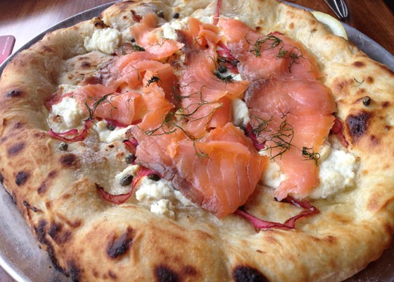 Pizza topped with smoked salmon, ricotta, capers, dill and red onion. | Nancy Stiles
