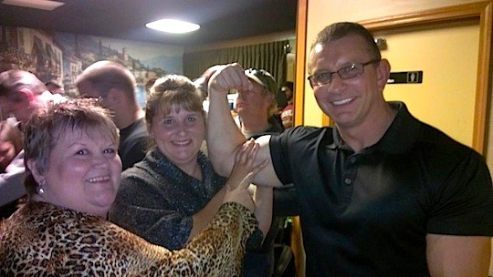 Diane Emery and Robin Beard Gordon of Caseyville Cafe check out Robert Irvine's muscles. - image via