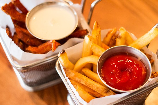 Sides of fries and sweet potato fries.