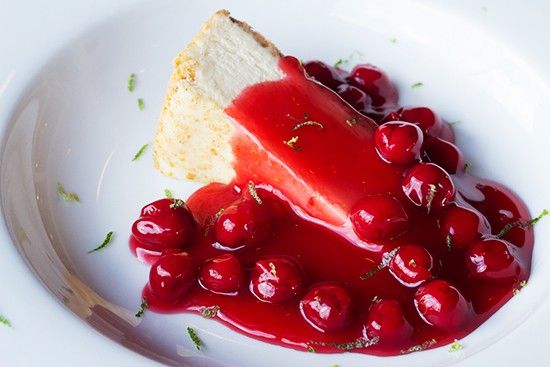 Cheesecake topped with bourbon cherry sauce and fresh lime zest.