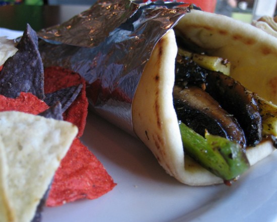 Yellow squash, zucchini, portabella mushrooms, green peppers, onions and feta drizzled with Italian dressing wrapped in pita bread at MoKaBe's. - REASE KIRCHNER
