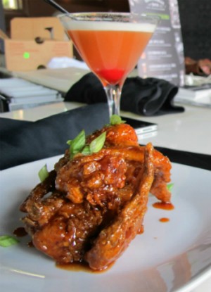 The chicken wings with a "Pineapple Upside Down" cocktail at Soho. - Rease Kirchner