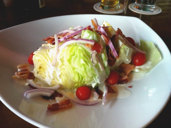 The wedge salad at the Shaved Duck, piled high with iceberg lettuce, crispy bacon, cherry tomatoes and shaved red onion bathed in tangy ranch dressing. - Liz Miller