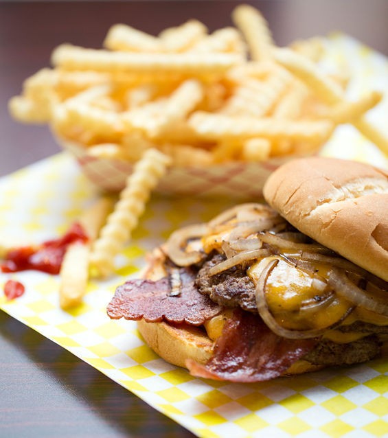 A "Double Chubbie Cheddar" comes stacked with two patties, cheddar and carmelized onions. Seen here with the addition of bacon and a side of crinkle fries. - Jennifer Silverberg