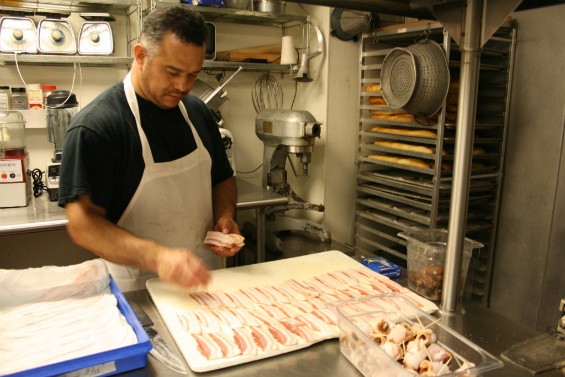 Dinsmoor's other assistant, Jesus Garcia, preps bacon-and-date wraps. - Chrissy Wilmes