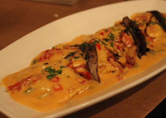Seafood ravilio with sherry wine, sun-dried tomato, trinity of pepper in a tomato cream sauce and garnished with roasted portobello mushrooms with a balsamic reduction. | Nancy Stiles