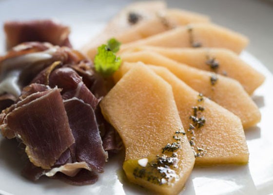Prosciutto de Parma and melon slices, white balsamic reduction and mint oil. | Jennifer Silverberg