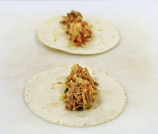 Place the chicken mixture on the tortillas. See more photos. - Photo: Jennifer Silverberg