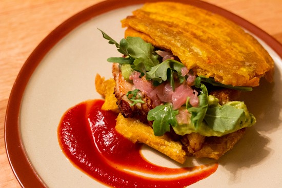 El Jibarito, a fried plantain "sandwich" with pork belly, tomato-chipotle jam, avocado and pickled red onion. - Mabel Suen