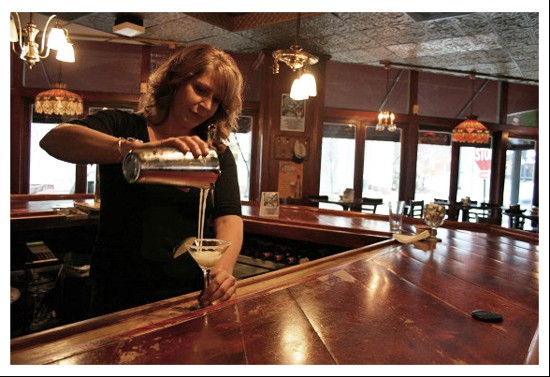 C.J. Muggs bartender Melissa Pfeiffer gracefully pours a key lime martini. - Chrissy Wilmes