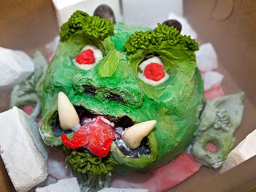 Soraci's favorite cake, the Green Devil, is made from peanut butter and chocolate cake, with green- and red-dyed white-chocolate ganache. The hair is made up of chocolate modeling paste. - PHOTO: STEW SMITH