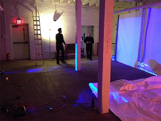 Visual artists Chad Eivens and Kevin Harris prep for the show this Thursday by setting up giant screens for full-color video projections. - Courtesy of Jeremy Kannapell