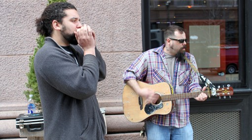 Brown Bottle Fever, a busking duo from South St. Louis, plays outside the Flamingo Bowl on Thursday. One St. Louis man wants busking to become a regular occurrence on Washington, and has plans to bring them downtown.