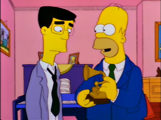 Homer Simpson proudly displays his Grammy Award for Outstanding Soul, Spoken Word or Barbershop Album.